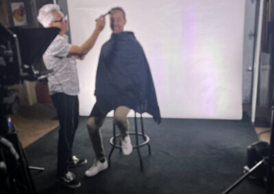 A woman is getting her hair cut by another person.