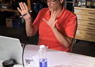 A man sitting at a table with a laptop.