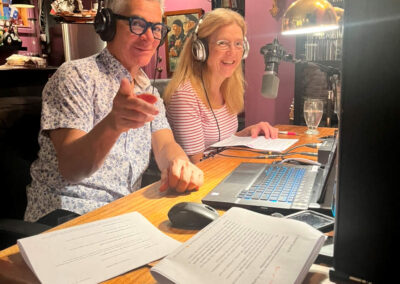 Two people sitting at a table with papers on the desk